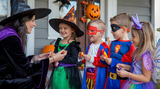 A lady giving halloween chocolates to children